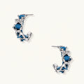 White gold plated hoop earrings with woven blue denim fabric through organic branch-like metal framework