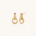 Gold stud earrings with vertical ridged bar connecting to triple interlocking circular rings on white background