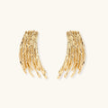 Gold-toned statement earrings with cascading liquid metal-inspired strands on white background.